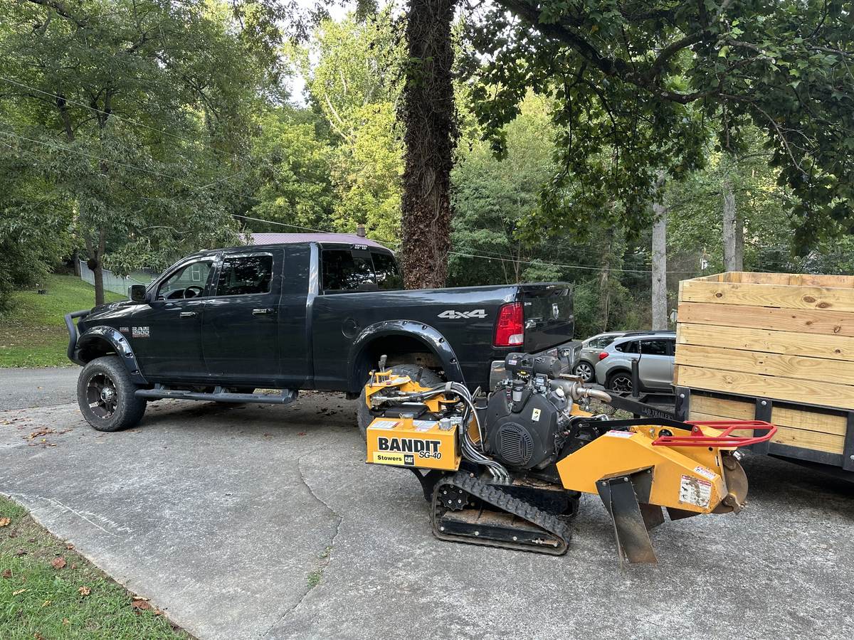 Solaterra truck, trailer, and stump grinder rig